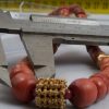 di coralli rossi cilindrici e argenti indiani dorati